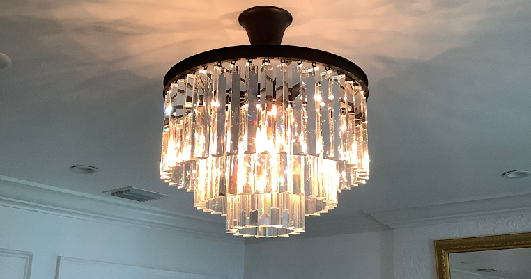 A large crystal chandelier elegantly suspended from the ceiling, reflecting light and adding sophistication to the room.
